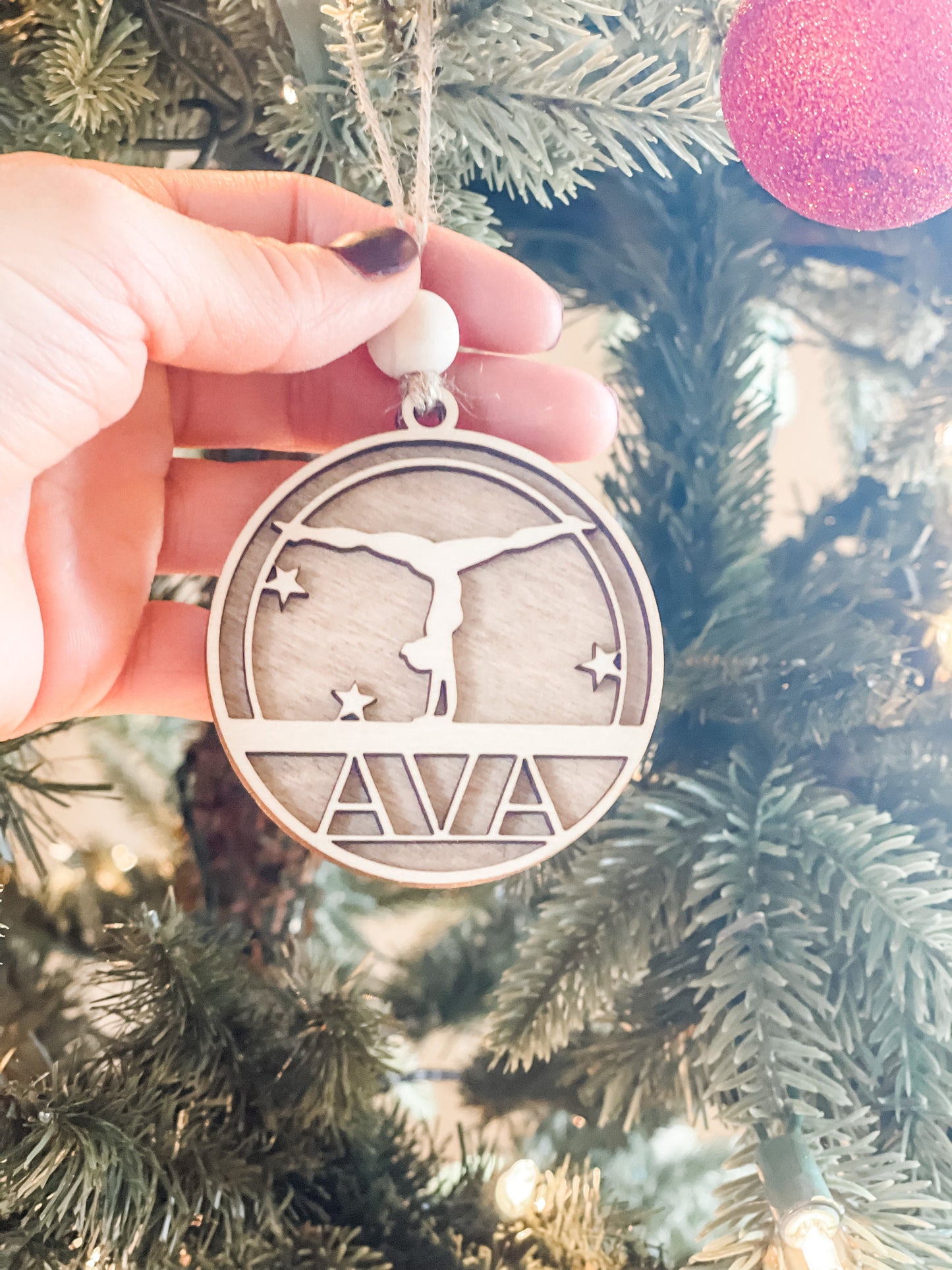 This is a beautiful ornament with dual wood tones of white birch and walnut stain. It’s accessorized with a wooden bead and brown twine for a natural look all around!